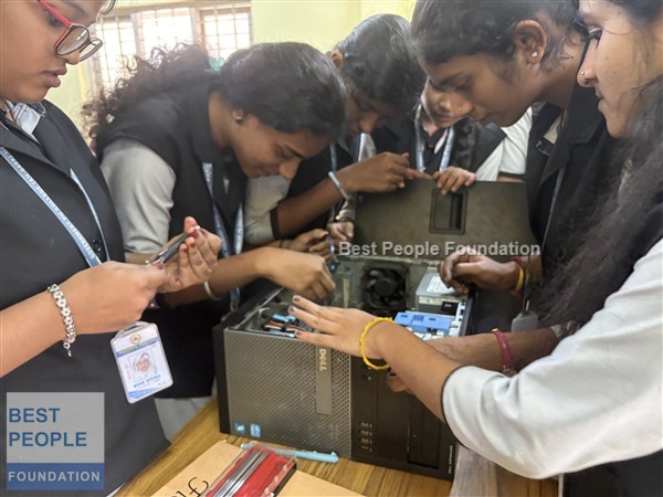 Students examining a computer power supply