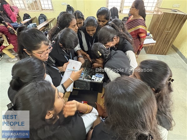 Students examining motherboard components during the workshop