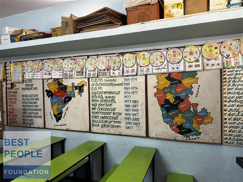 Students raising hands excitedly in the computer lab