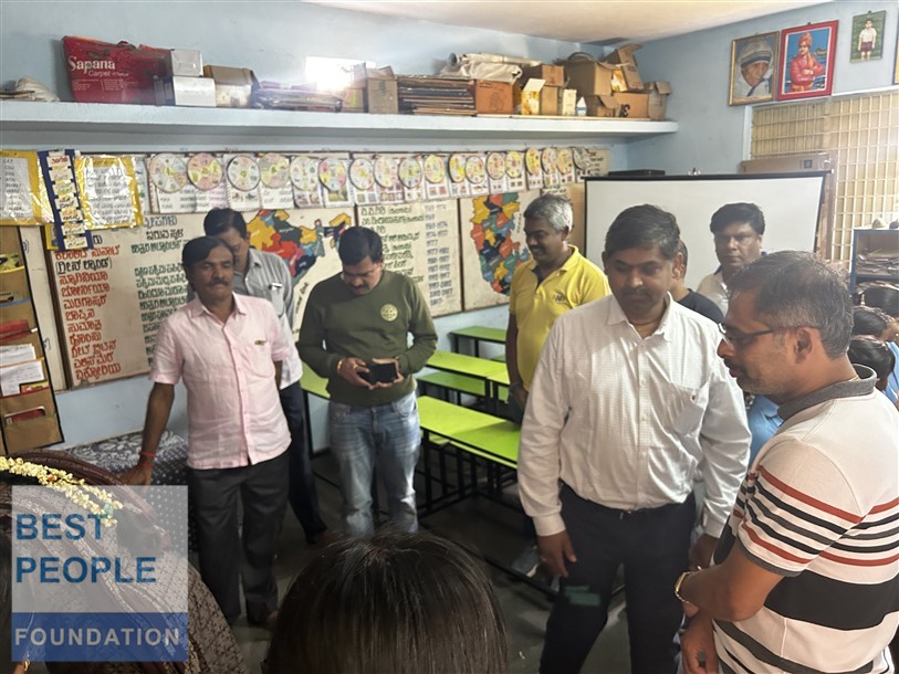 Teacher demonstrating computer usage to students